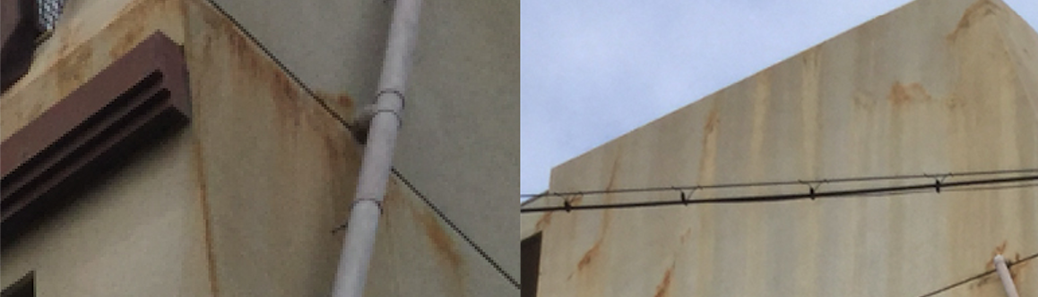 コンクリート建物の外壁面にさび色の雨ダレ汚れが発生